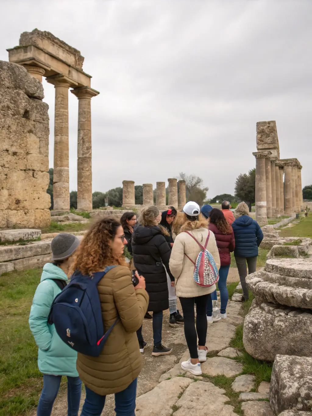 An image of a guided tour group exploring the architectural details of Logis de Chalonne, emphasizing the educational aspect of the tours.